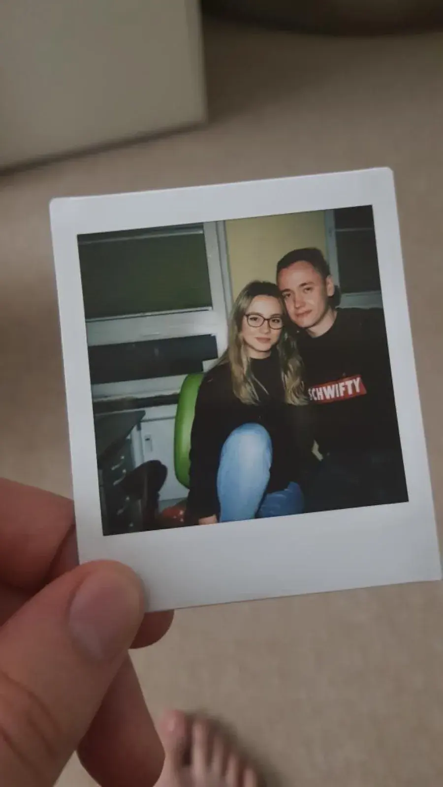 A Polaroid photo of Erik and Darja, held up by hand